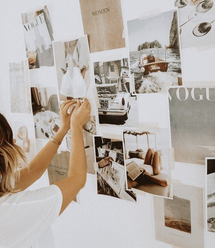 Female specialist from our media relations agency hanging up earned media strategies for Vogue.